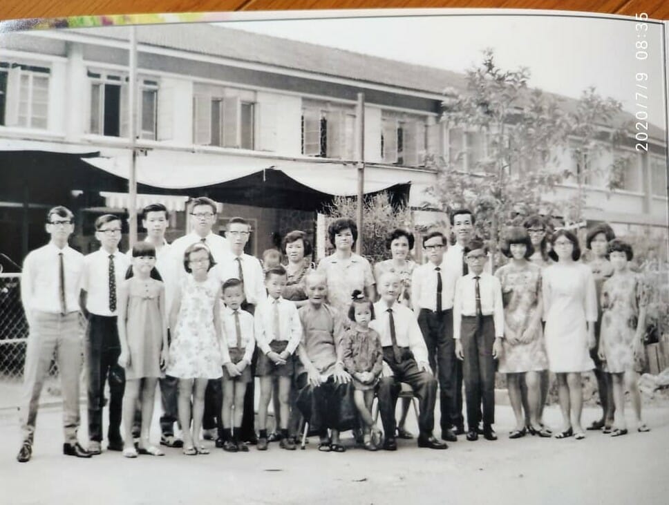 [Family photo of my great grandparents and their brood. Grandpa (the tallest guy from right) and mom (girl in white from right).]