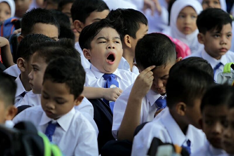 schoolkid yawning during morning assembly