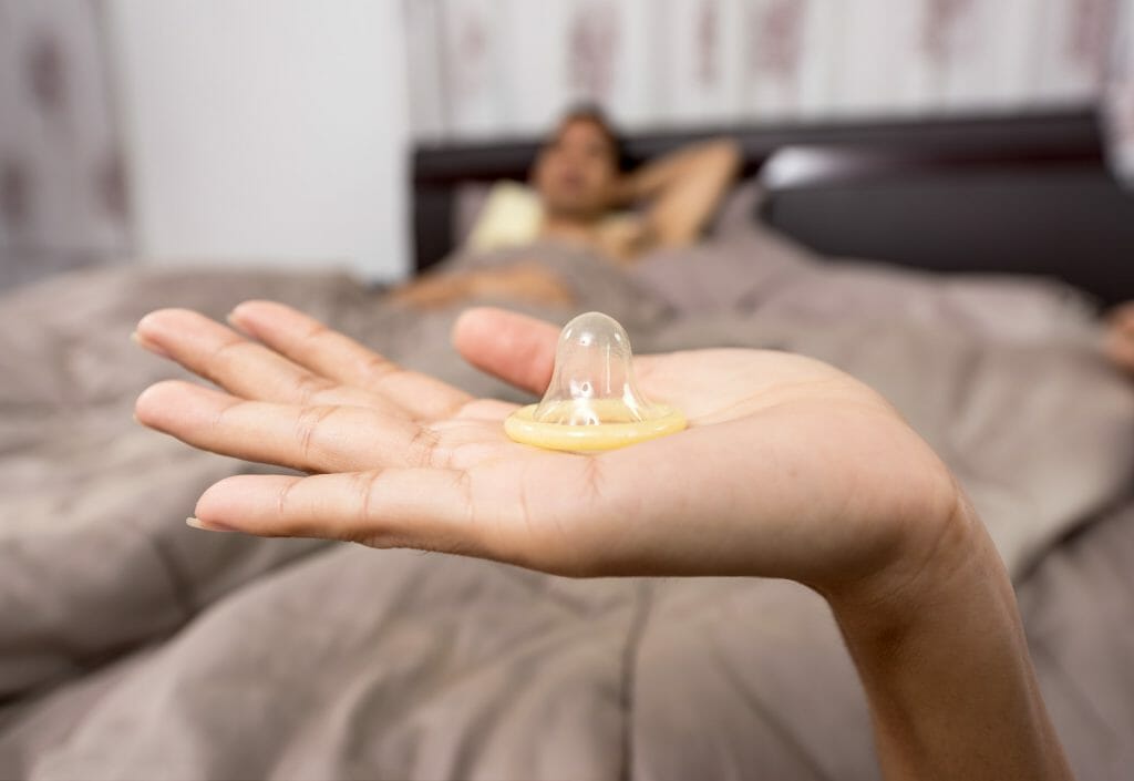 close up of woman holding condom 248148