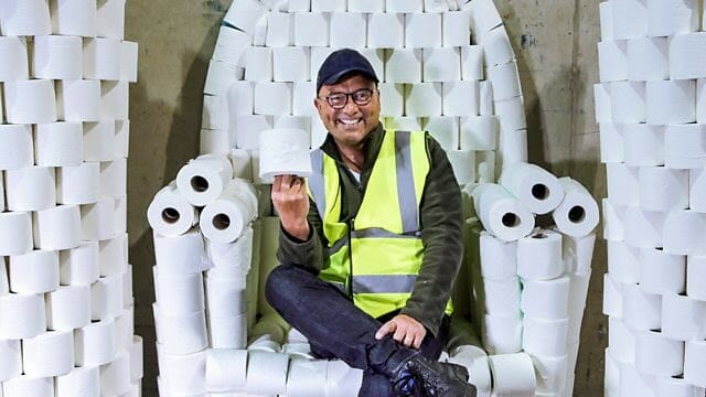 Man Sitting On A Throne Of Toilet Paper.