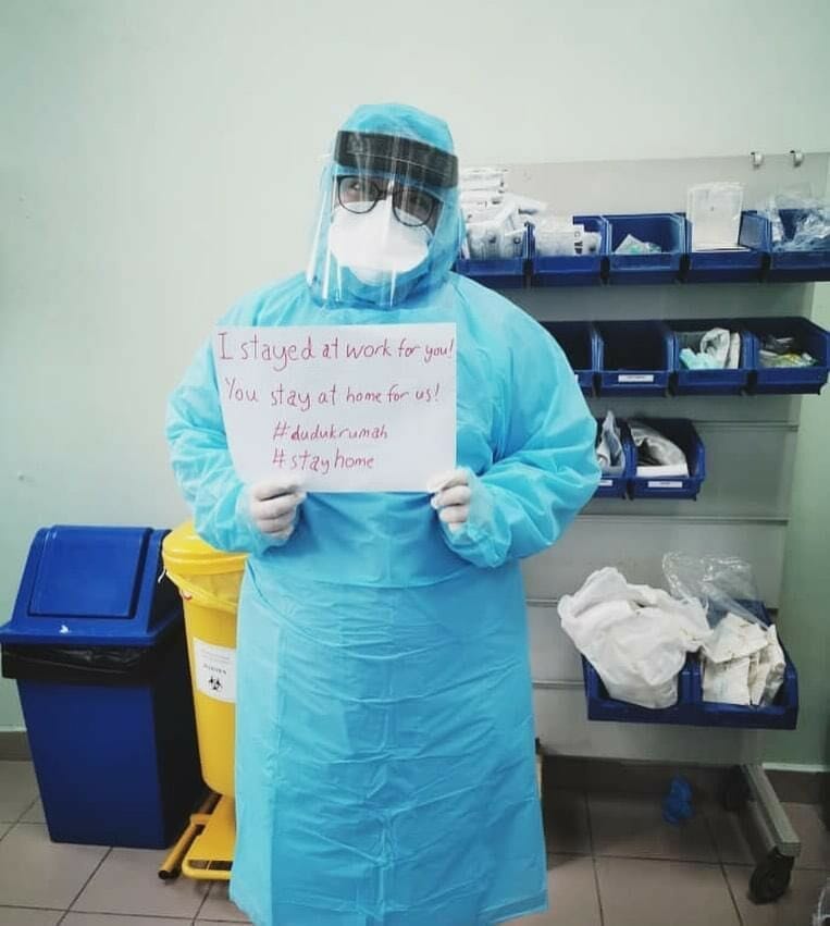 Doctor Wearing Ppe Holding A Sign Saying &Quot;I Stayed At Work For You!&Quot;
