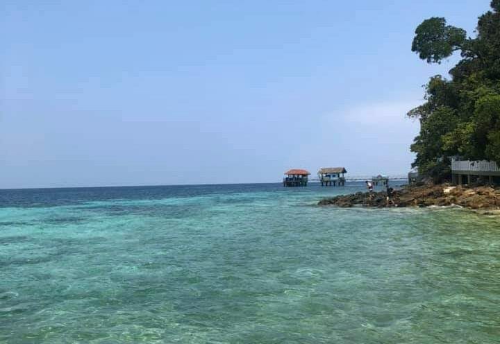 The sea at Pulau Tioman, calm waters during a clear, sunny day.