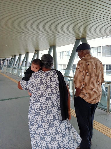 Arya draped in my grandma's shawl while walking them to the MRT.