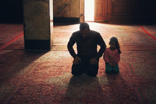 Muslim Father And Daughter Praying.