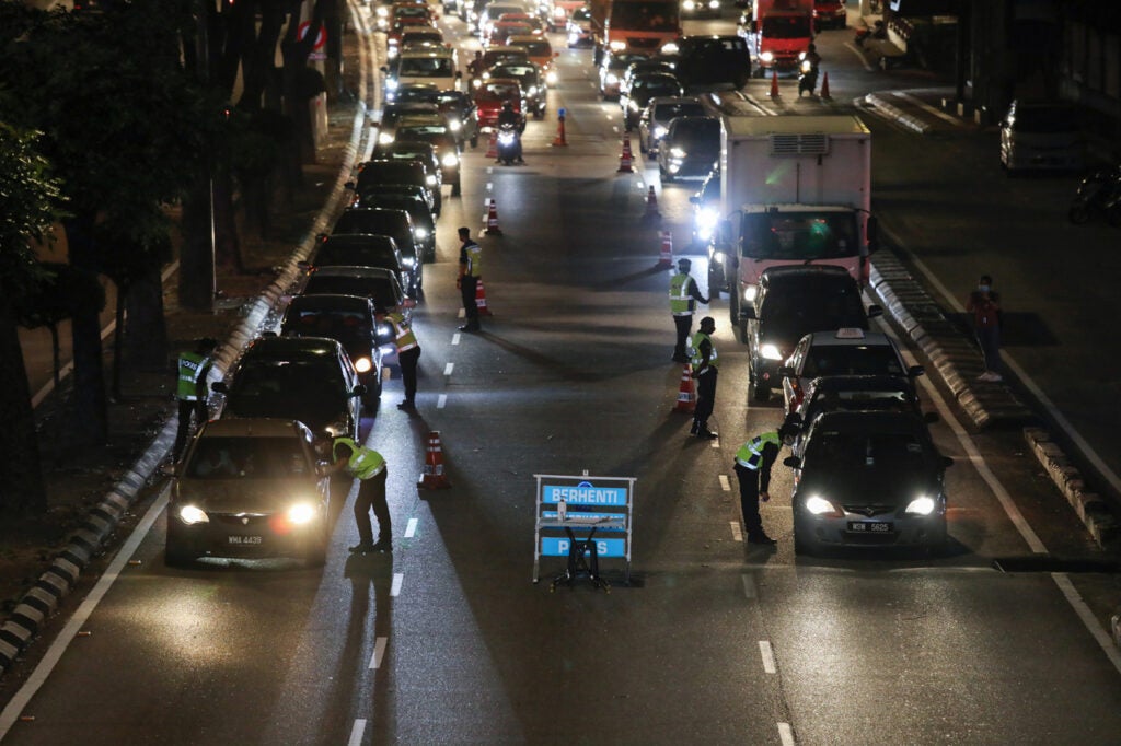 Police Officers Check Vehicles At A Roadblock To Enforce Movement Control Order Due To The Spread Of The Coronavirus Disease (Covid-19), In Kuala Lumpur, Malaysia March 19, 2020. Reuters/Lim Huey Teng