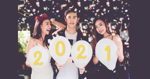 Party people. Two asian women and one man Standing holding White balloons with 2021 symbol New Year celebrating