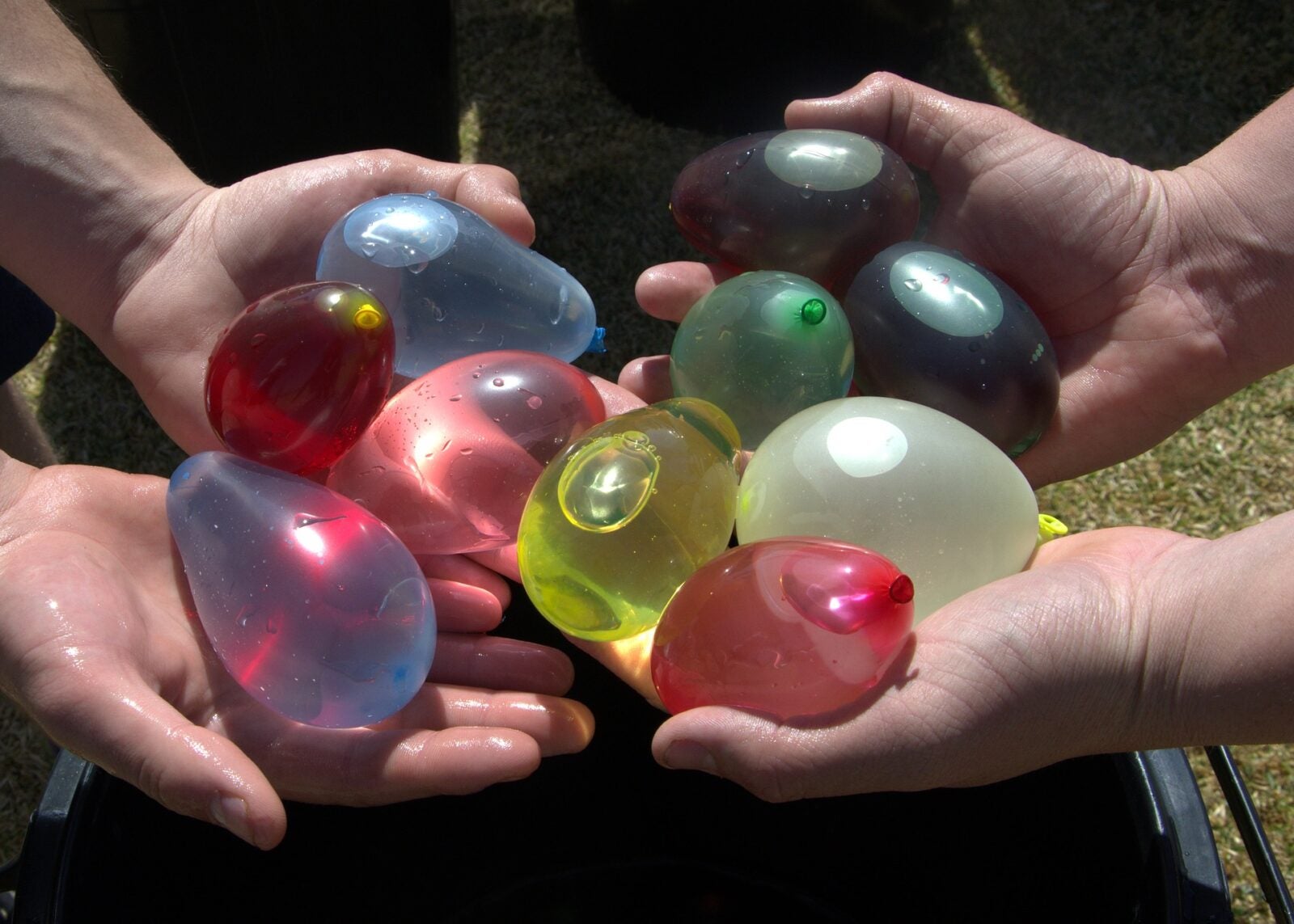 Hands Holding Water Balloons