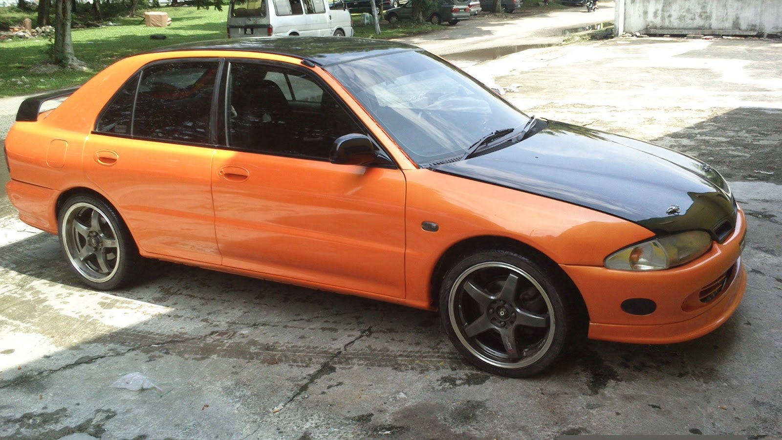 orange and black Proton car