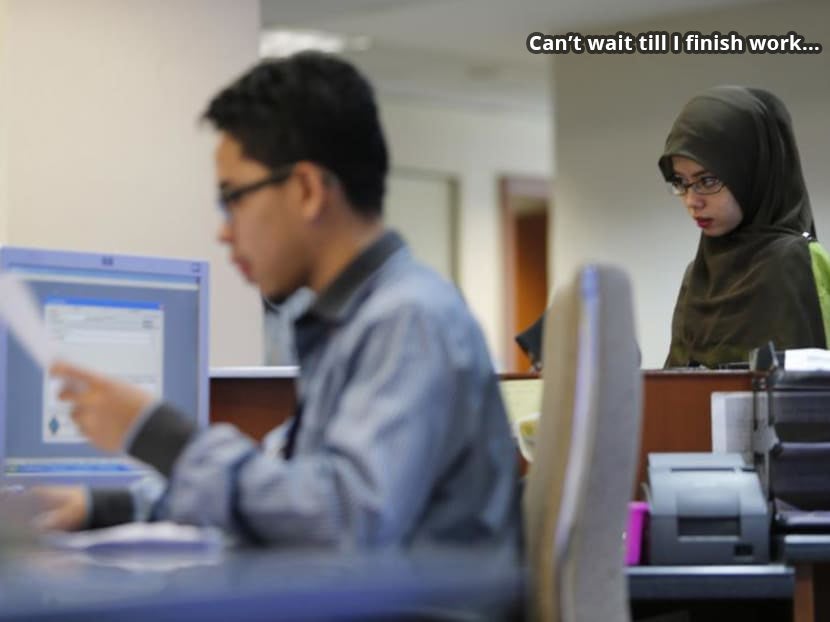Malay woman worker in office thinking: "Can't wait till work finishes"