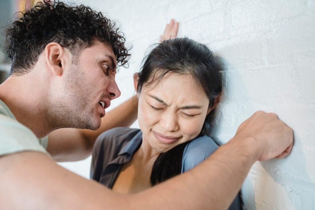 Husband Hitting The Wall Next To Wife