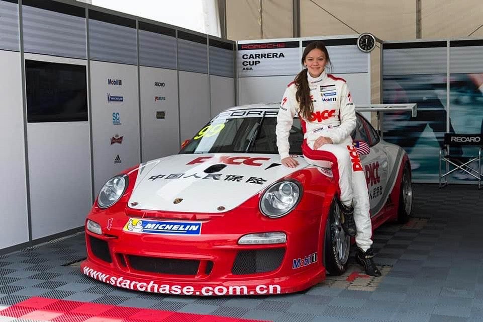 Natasha Seatter posing with her race car.