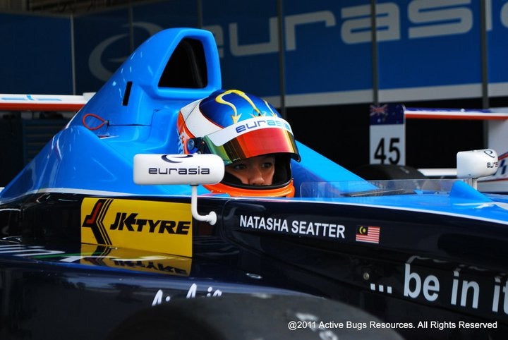 Natasha Seatter in a f1 car.