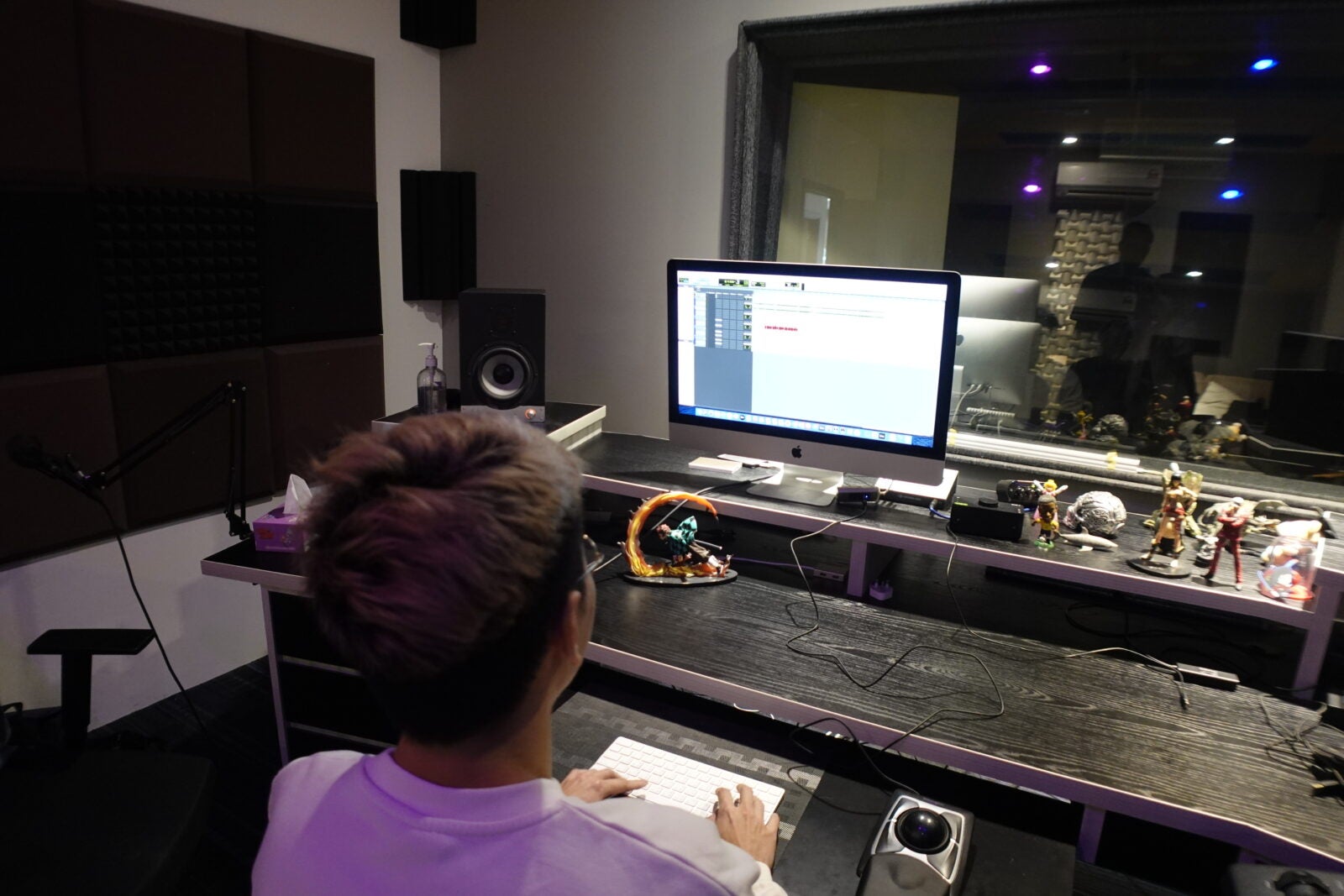 Yue Wai Ming sitting at his desk while looking at a music program in his studio at Petaling Jaya, Selangor.