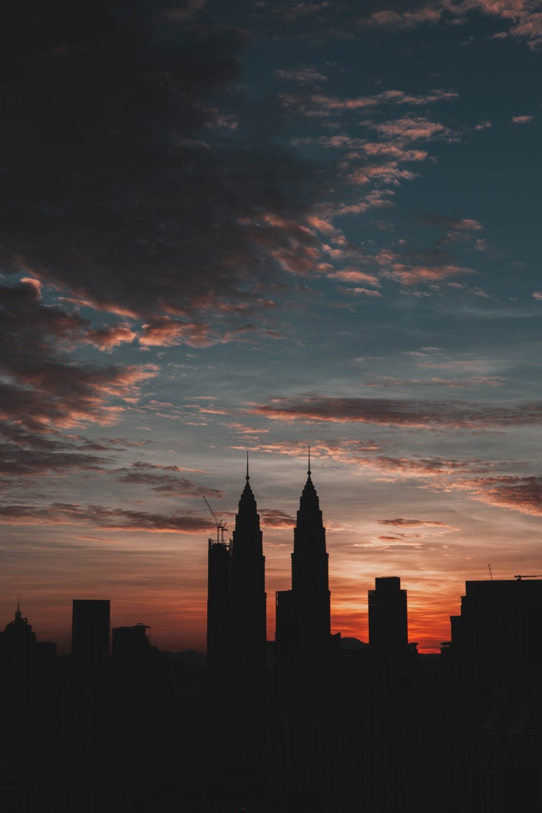 A sillhoutte of the Kuala Lumpur Twin Towers under the beautiful pink skies.