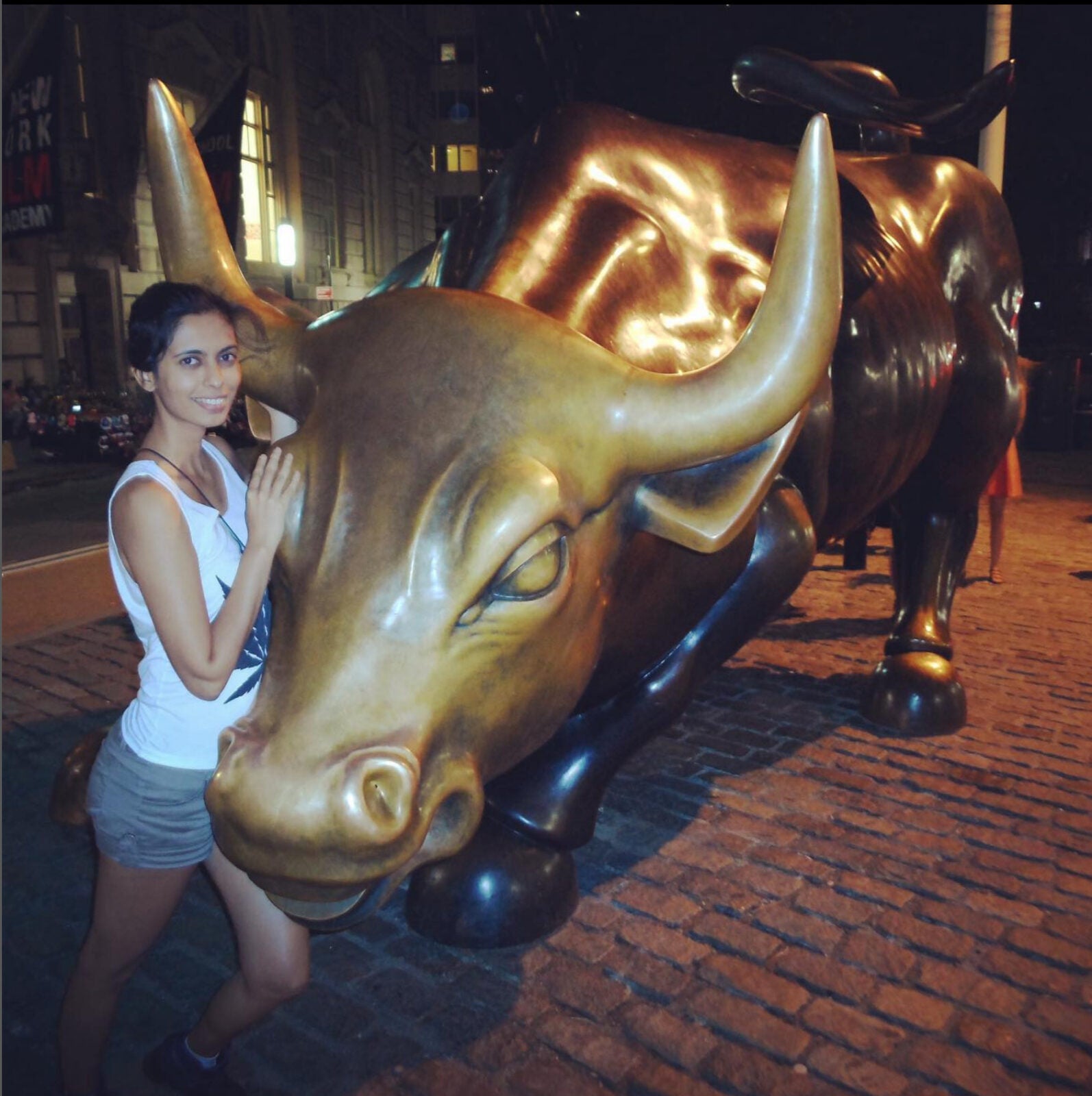 A Malaysian Indian Woman Posing With The Charging Bull In New York City