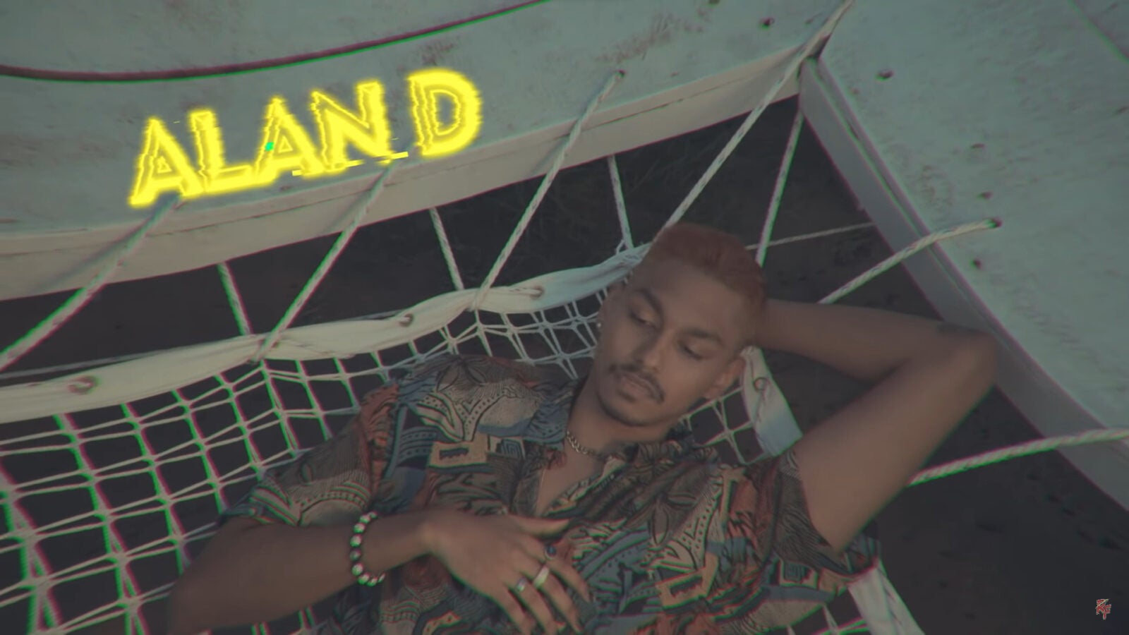 A Malaysian Indian Musician, Alan Durairaj laying down on a hammock in his music video IMSO with MK.
