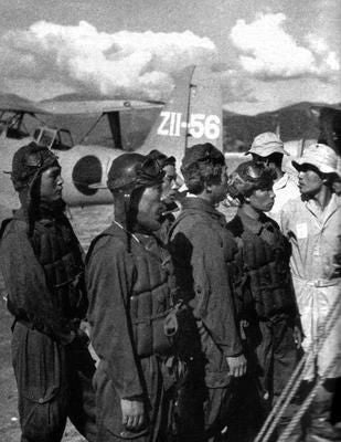 Old, black and white image of several Japanese flight fighters.