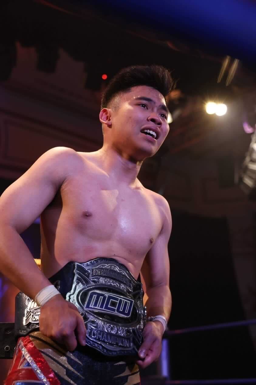 A young Malaysian man poses with his new championship belt after being crowned as the wrestling champion at the Melbourne Intercommonwealth Wrestling Championship