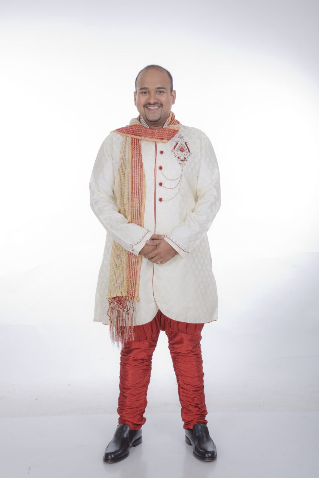 An Indian Man With A Beard Wearing Traditional Indian Clothes.