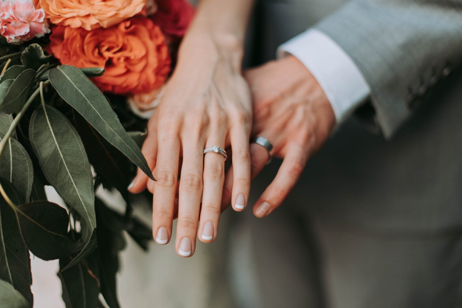 Close up of a married couple's hands showing their wedding rings.