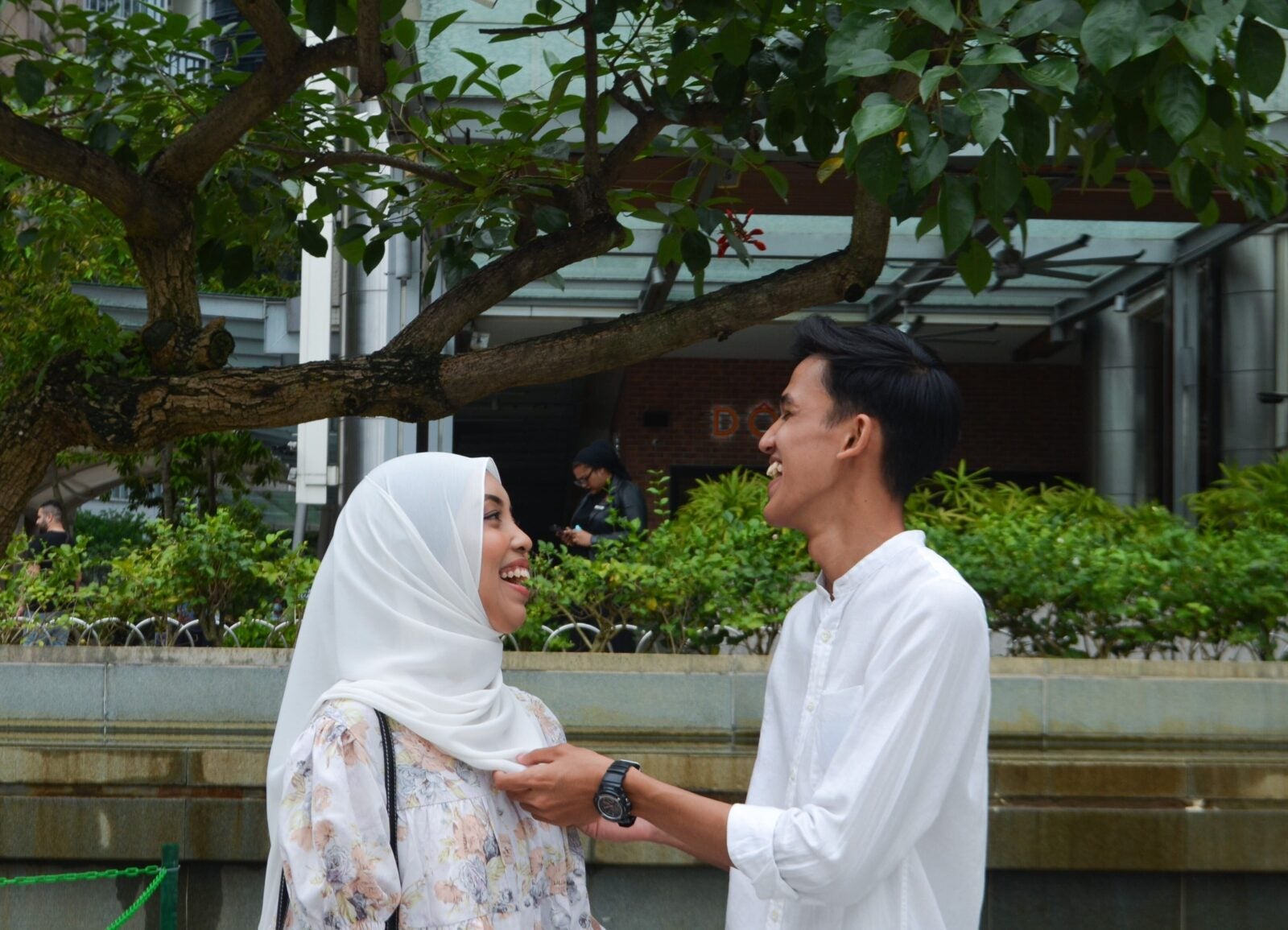 A Malay couple laughing together at KLCC park 2