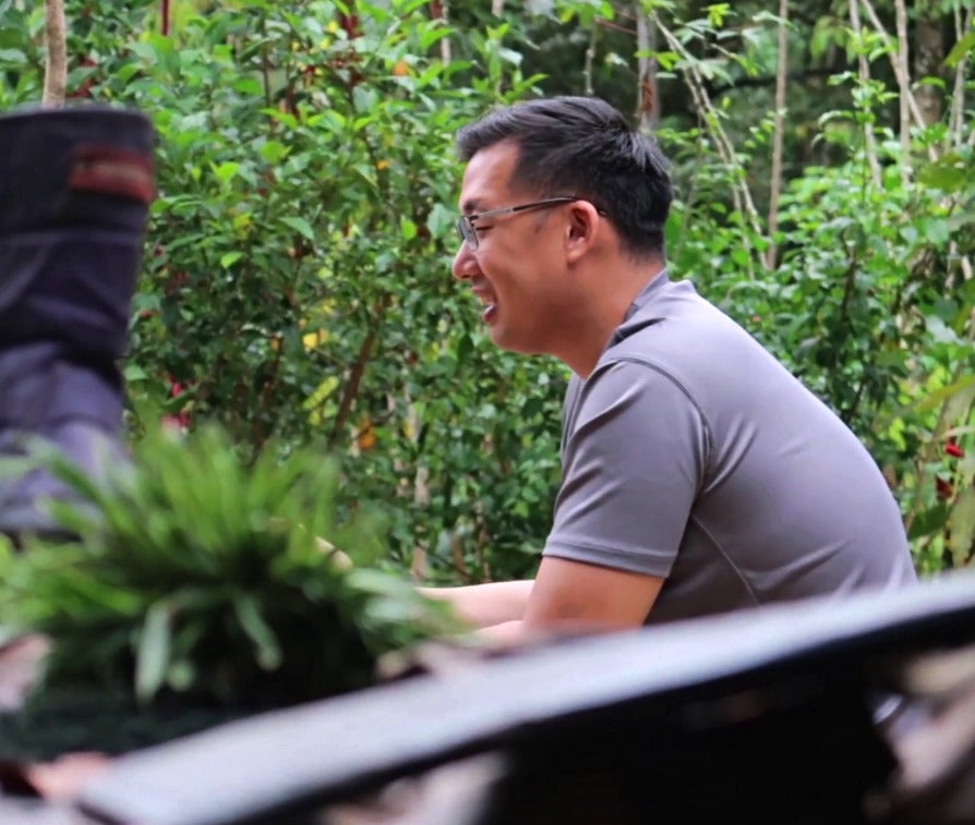 CEO of EPIC, John Son-Oei being interviewed in front of a home that his project built.