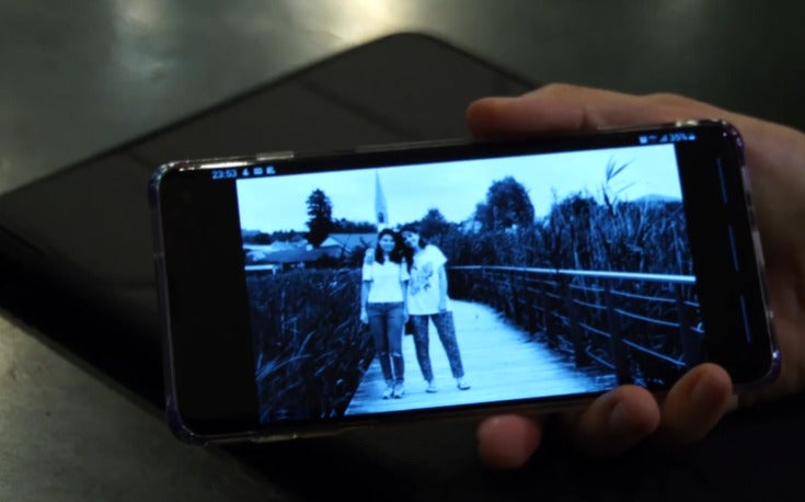 Close up of a phone screen which shows a photo of a Swiss woman with her Swiss-Chinese daughter