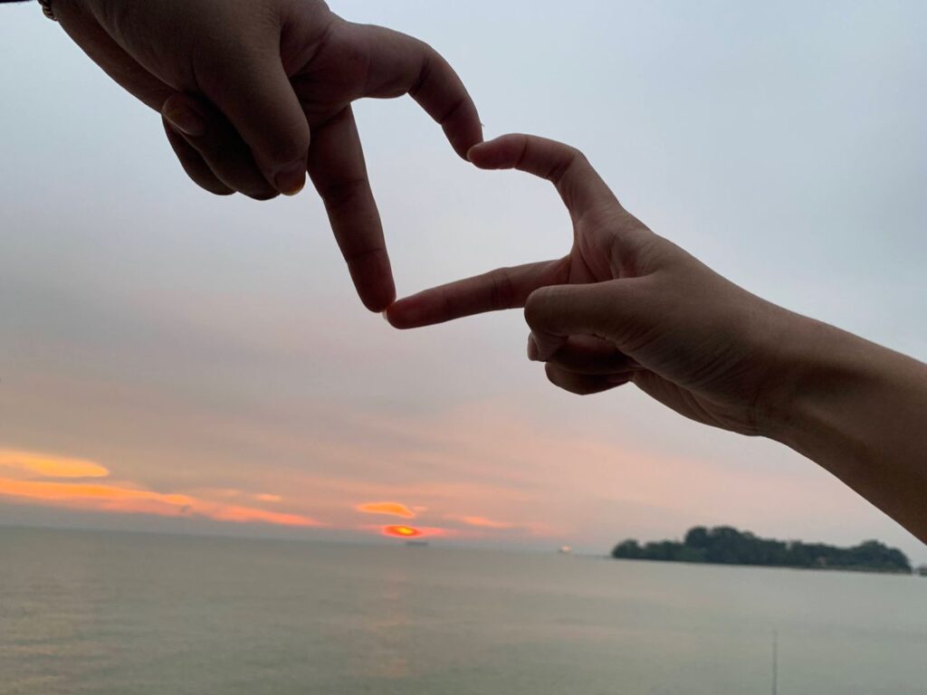 Two Hands Used To Create A Heart Shape Silhouetted Against The Malaysia Evening Sky