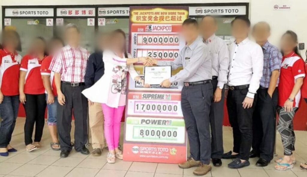 Toto Winner Accepting Their Cash Prize In Malaysia