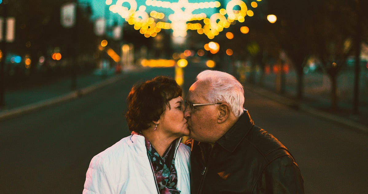 older couple kissing in a street