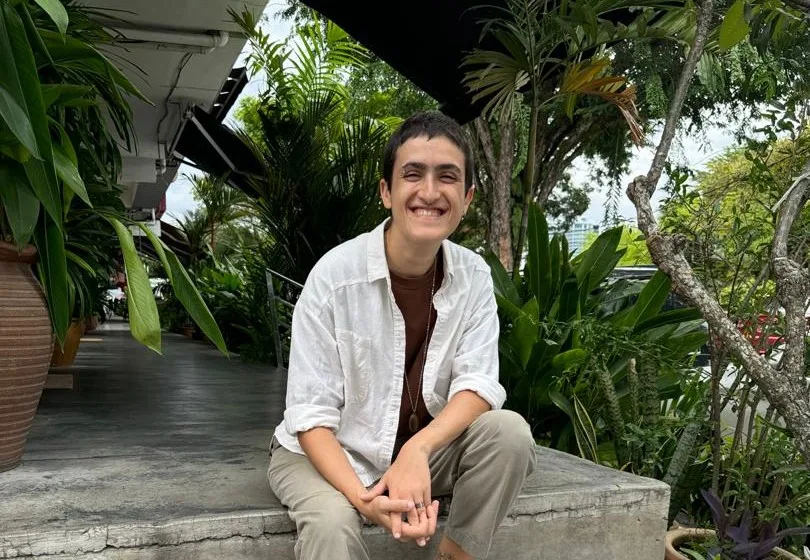 Amar Sitting On Some Steps In A Shoplot Area